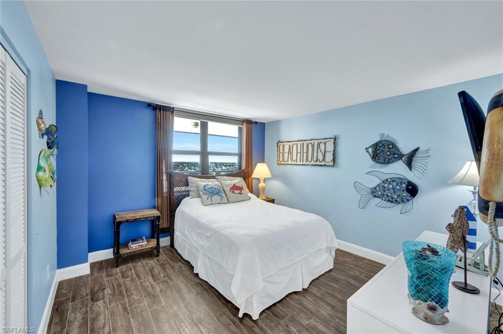 Bedroom featuring wood finish floors and a closet