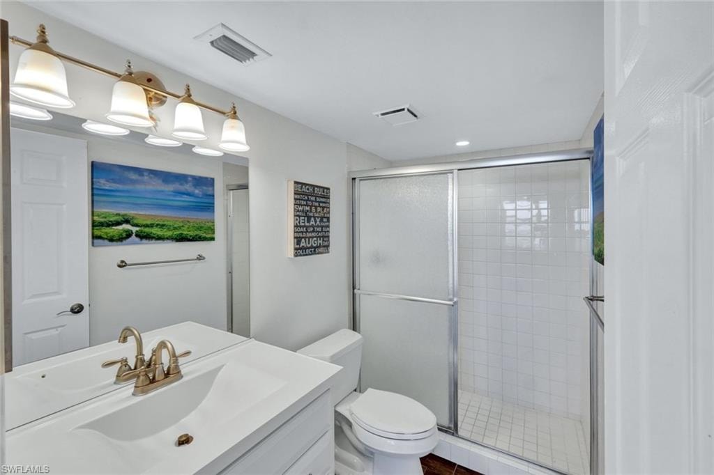 Bathroom featuring vanity and a shower stall