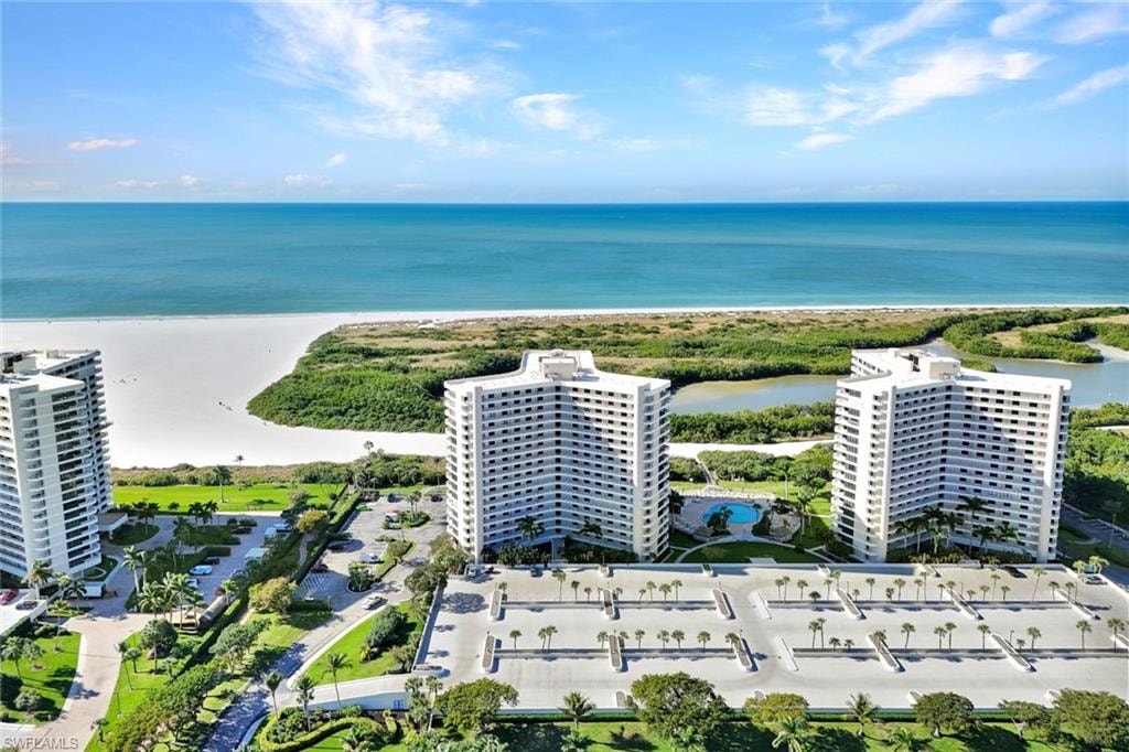 Drone / aerial view of apartment complex / building and a nearby body of water