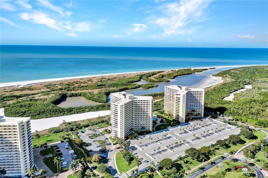 Drone / aerial view of unending shoreline and apartment complex / building