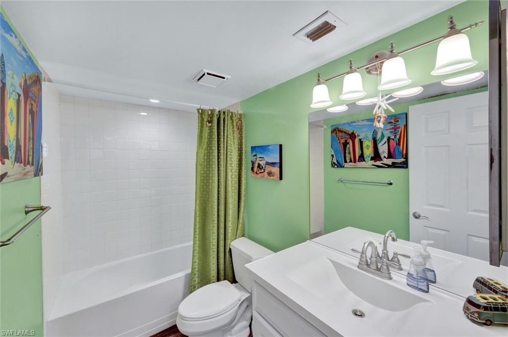 Full bath featuring shower / tub combo and vanity
