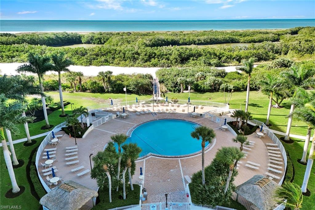Community pool with a yard and a water view