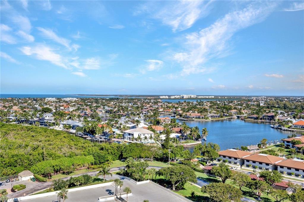 Aerial perspective of suburban area featuring a large body of water