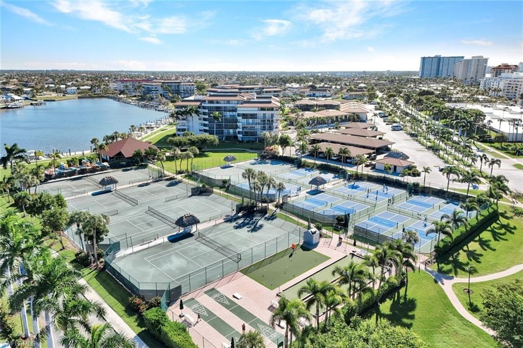 Aerial view of property and surrounding area featuring a nearby body of water and nearby urban area