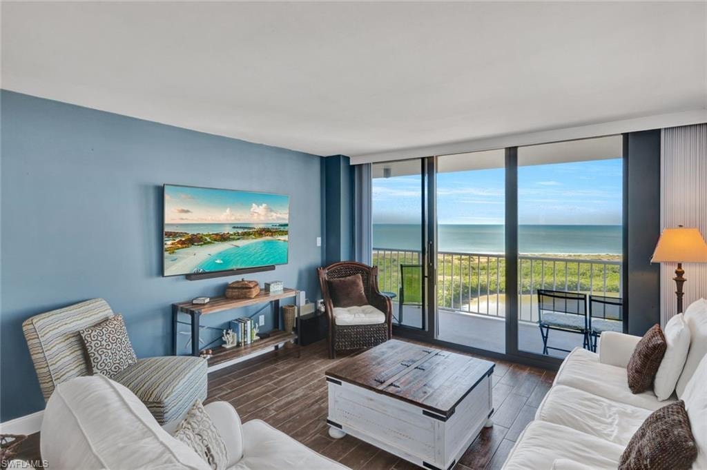Living area featuring floor to ceiling windows and wood tiled floors