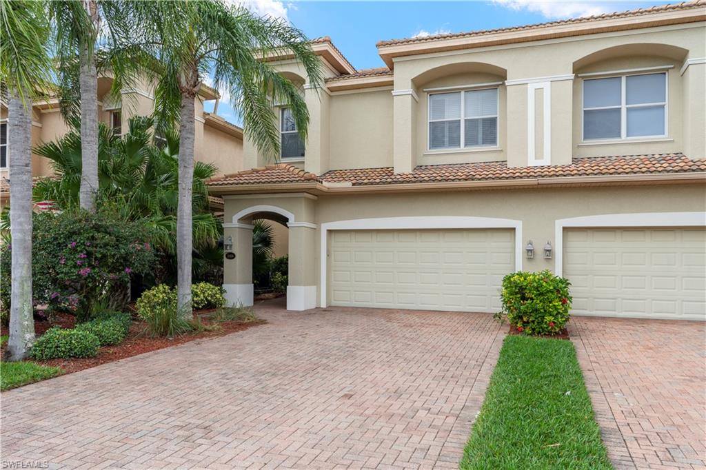 Mediterranean / spanish-style house featuring stucco siding, a tiled roof, and an attached garage