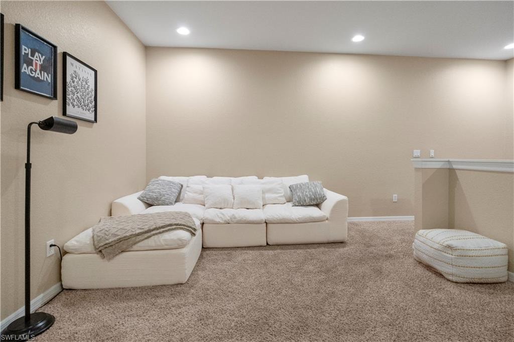 Carpeted living area featuring recessed lighting