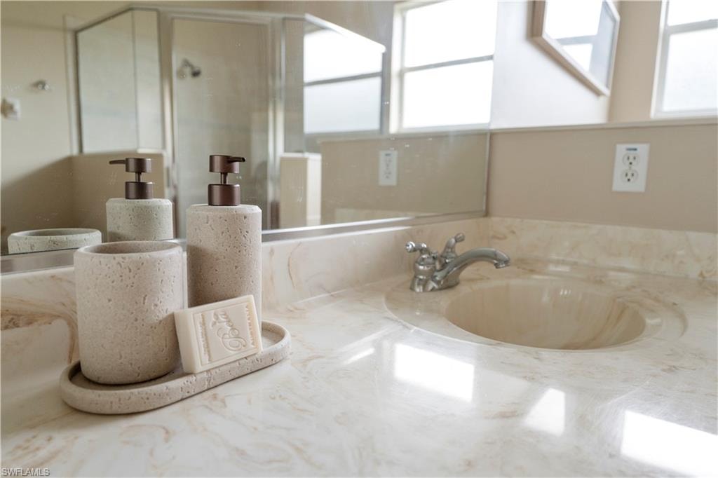 Full bathroom featuring a shower stall and vanity