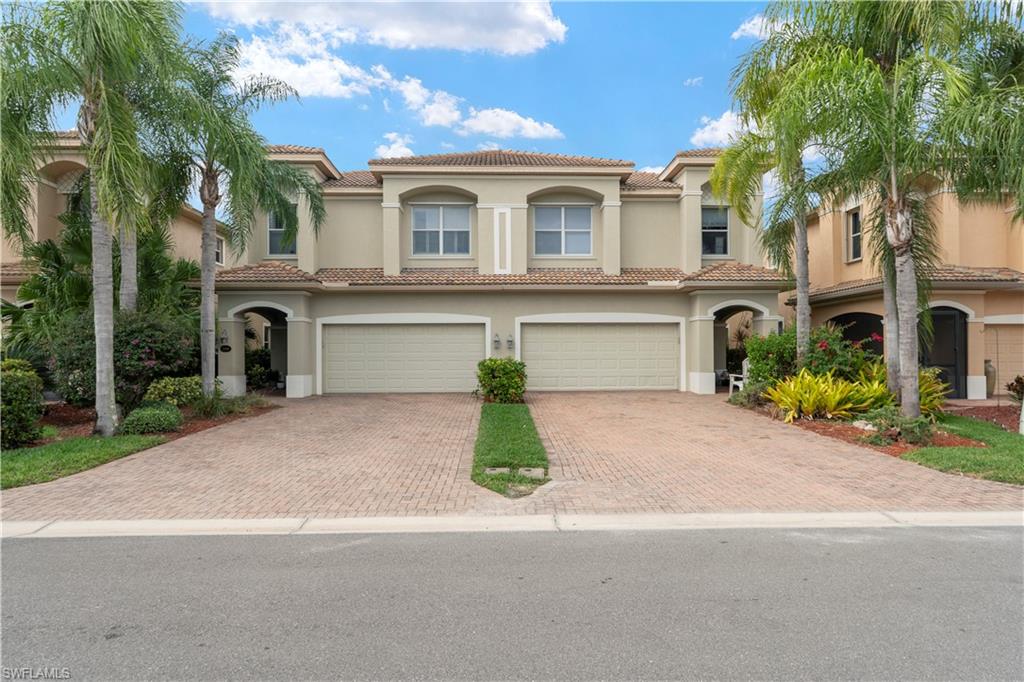 Mediterranean / spanish home featuring an attached garage, stucco siding, and a tile roof