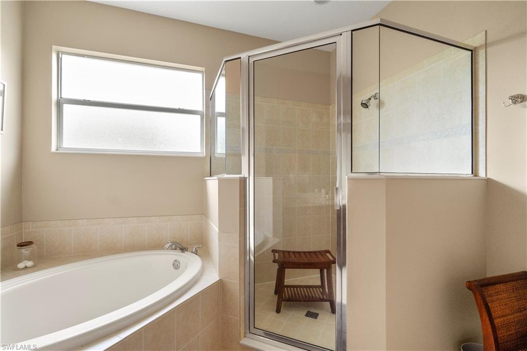 Bathroom featuring a stall shower and a garden tub