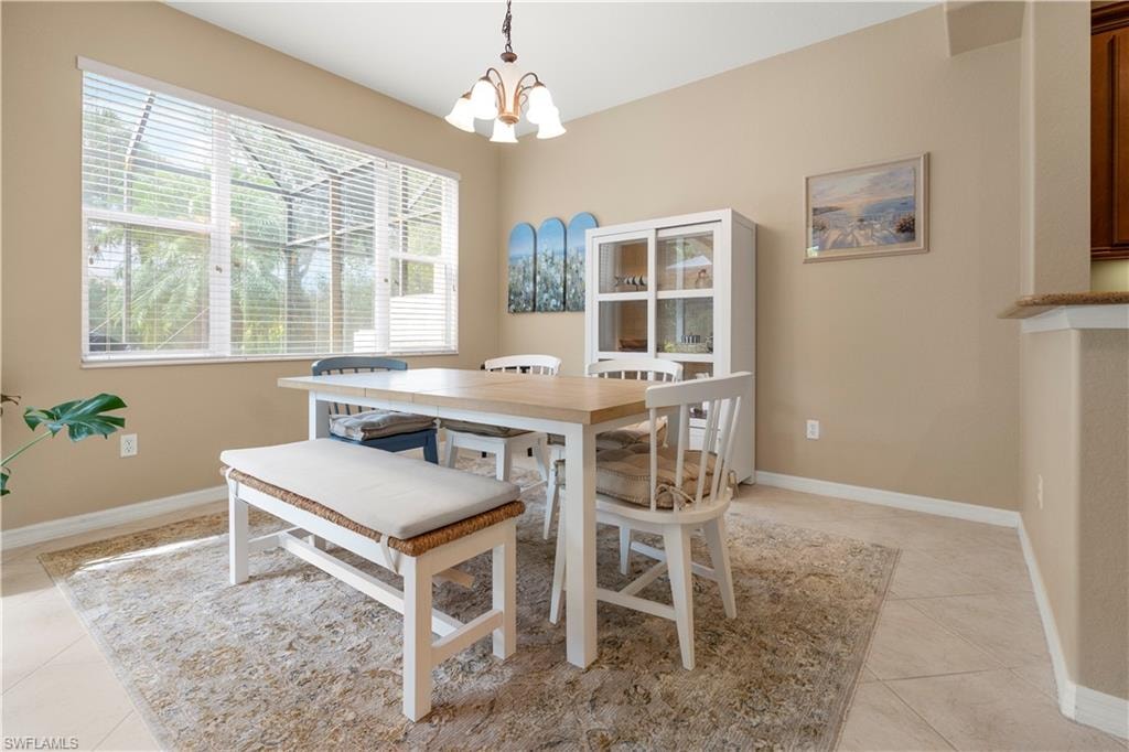Dining area featuring a chandelier and light tile patterned flooring