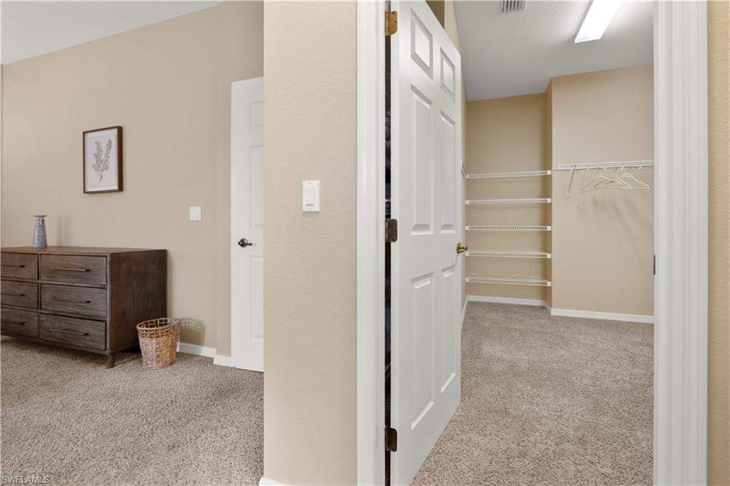 Hallway with light carpet
