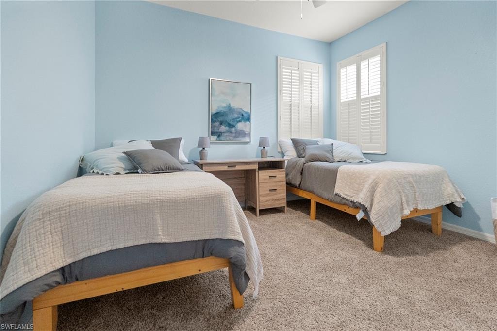 Bedroom with light carpet and ceiling fan