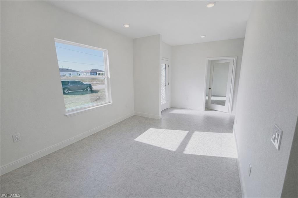 Empty room with recessed lighting and light floors