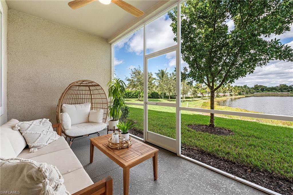 Sunroom with a water view, ceiling fan, outdoor lounge area, and vaulted ceiling