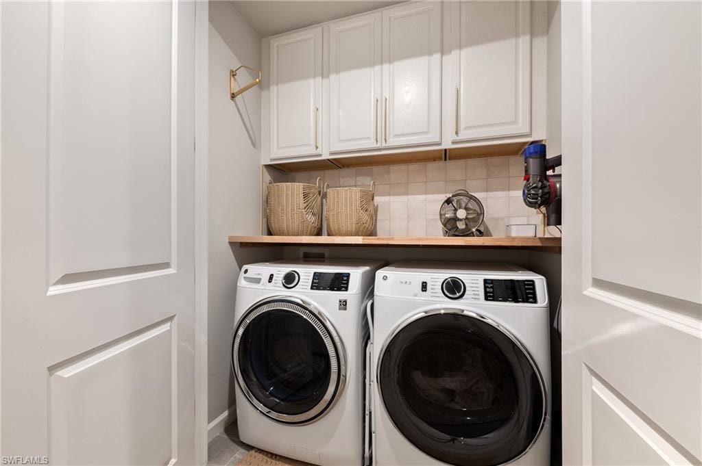 Laundry room with independent washer and dryer and cabinet space