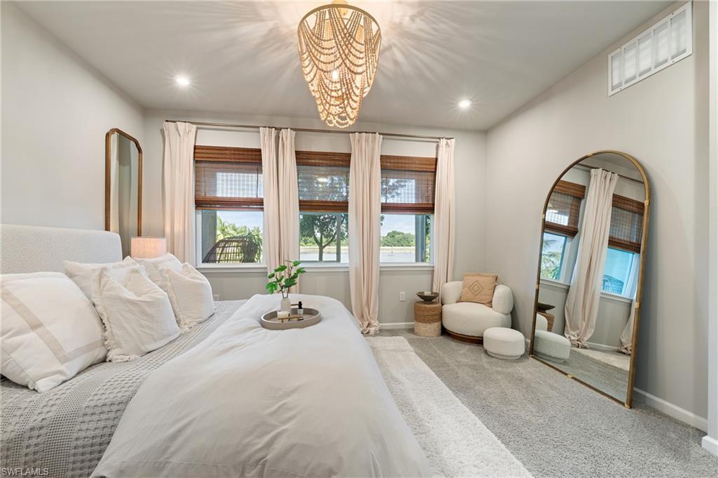 Bedroom with carpet, a chandelier, and recessed lighting