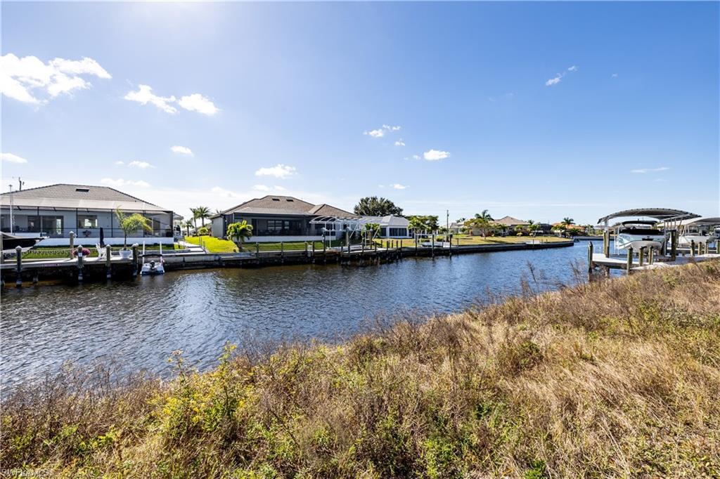 Dock featuring a residential view, a water view, and boat lift