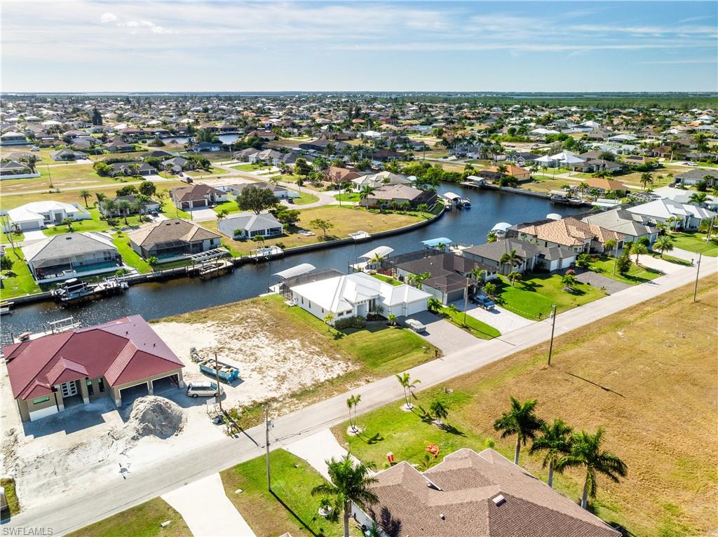 Aerial view of residential area featuring a nearby body of water