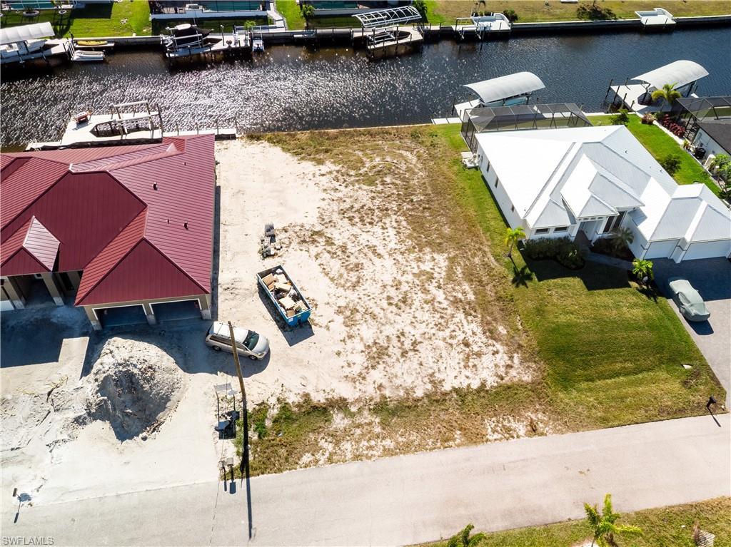 Aerial perspective of suburban area featuring a large body of water