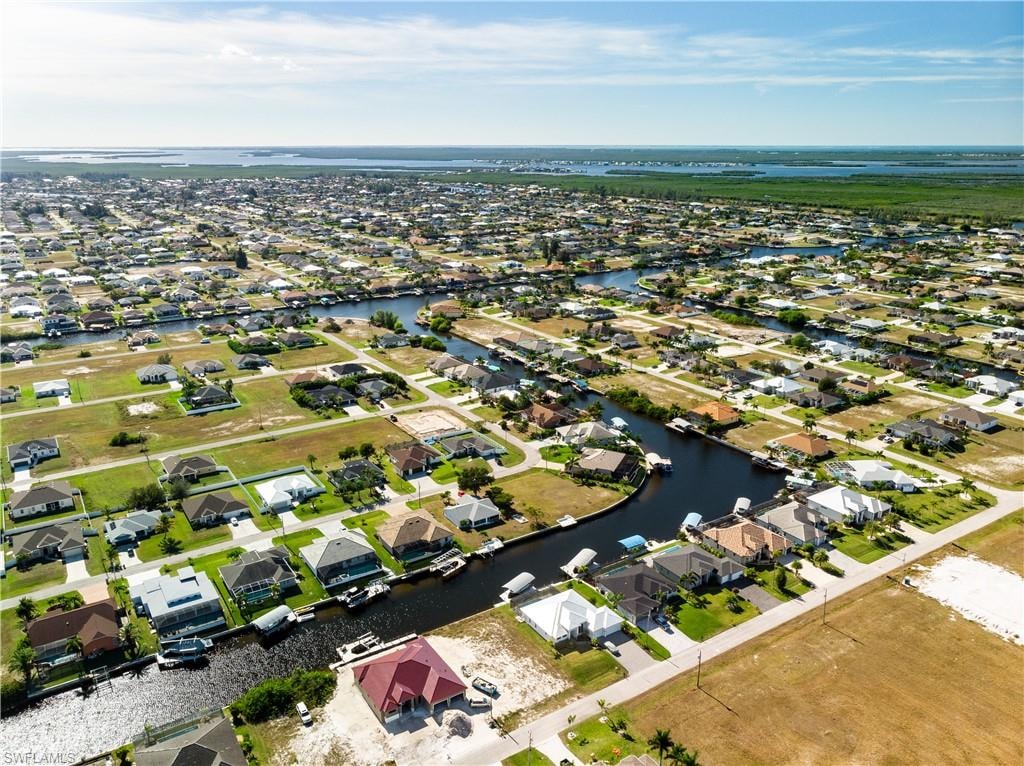 View of property location featuring a nearby body of water and nearby suburban area