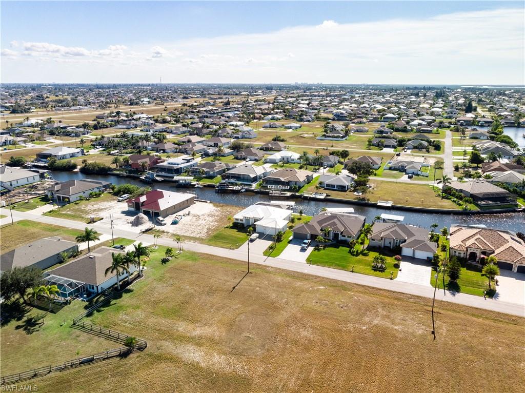 Aerial view of residential area featuring a nearby body of water