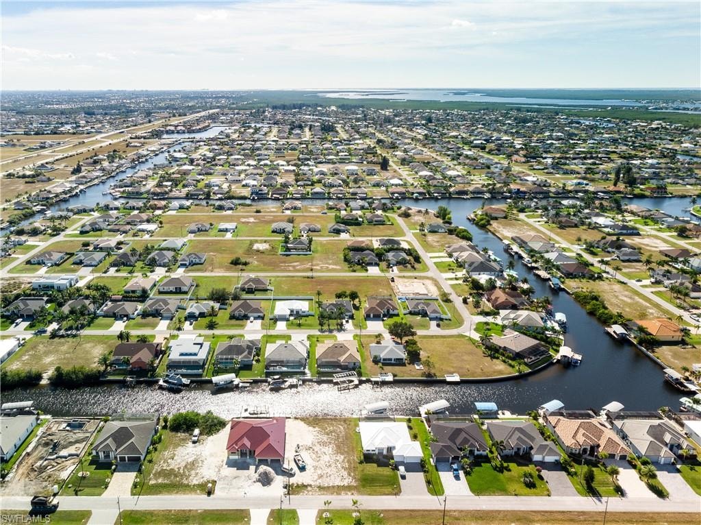 Aerial view of property's location with nearby suburban area and a nearby body of water