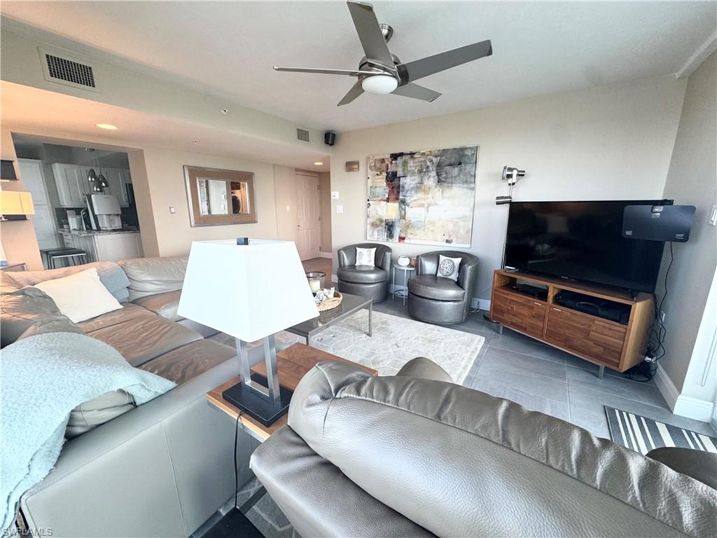 Living room with ceiling fan and baseboards