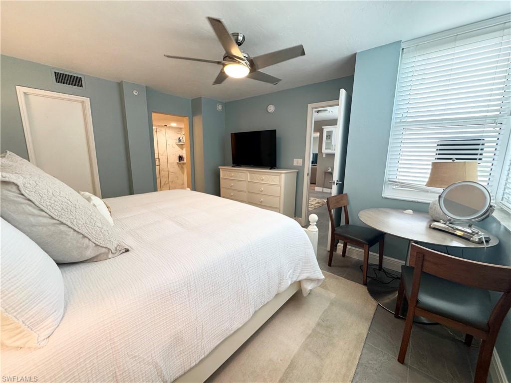 Bedroom featuring ceiling fan and ensuite bath