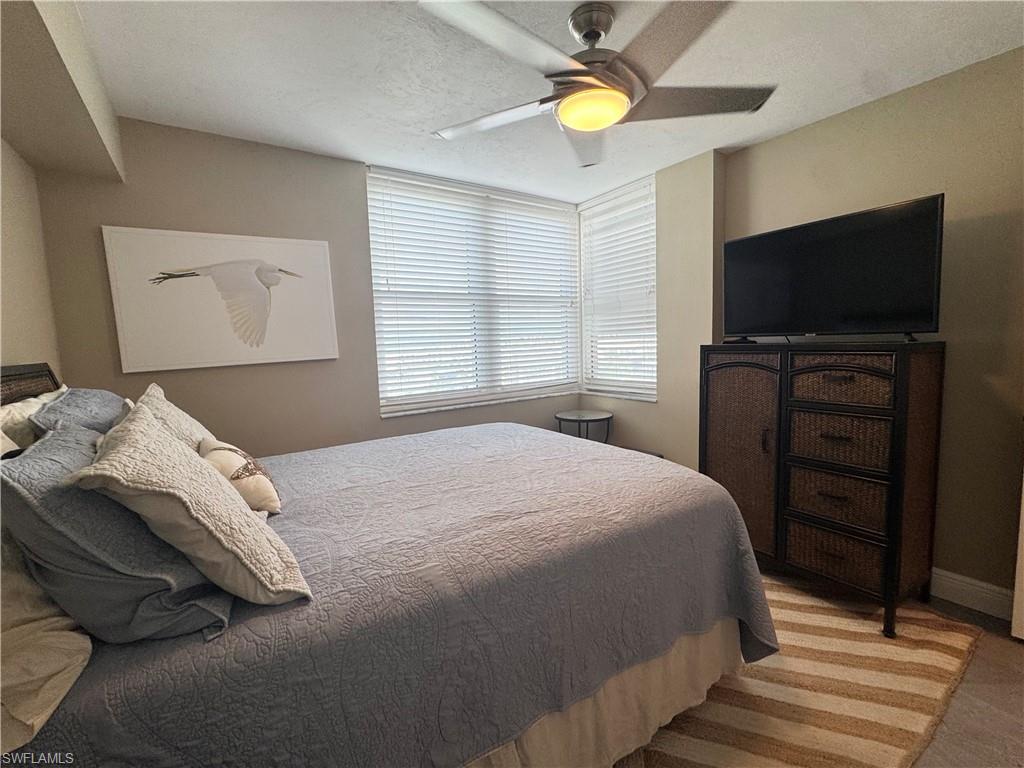 Bedroom featuring tile , queen bedroom and a ceiling fan