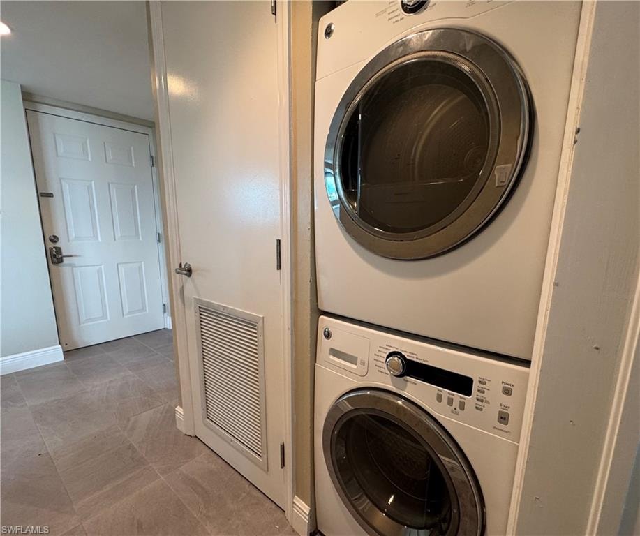 Laundry area featuring estacked washer and dryer and baseboards