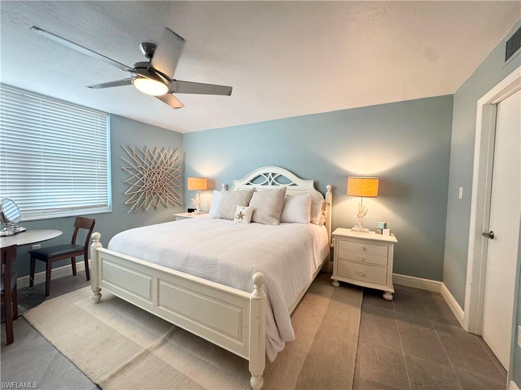 Bedroom featuring ceiling fan and baseboards