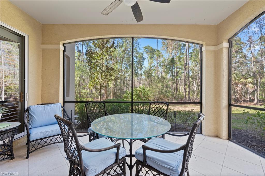 Sunroom with ceiling fan, outdoor dining area, and healthy amount of natural light