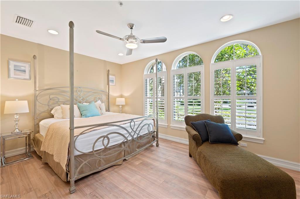 Bedroom featuring light wood-style floors, a ceiling fan, and recessed lighting