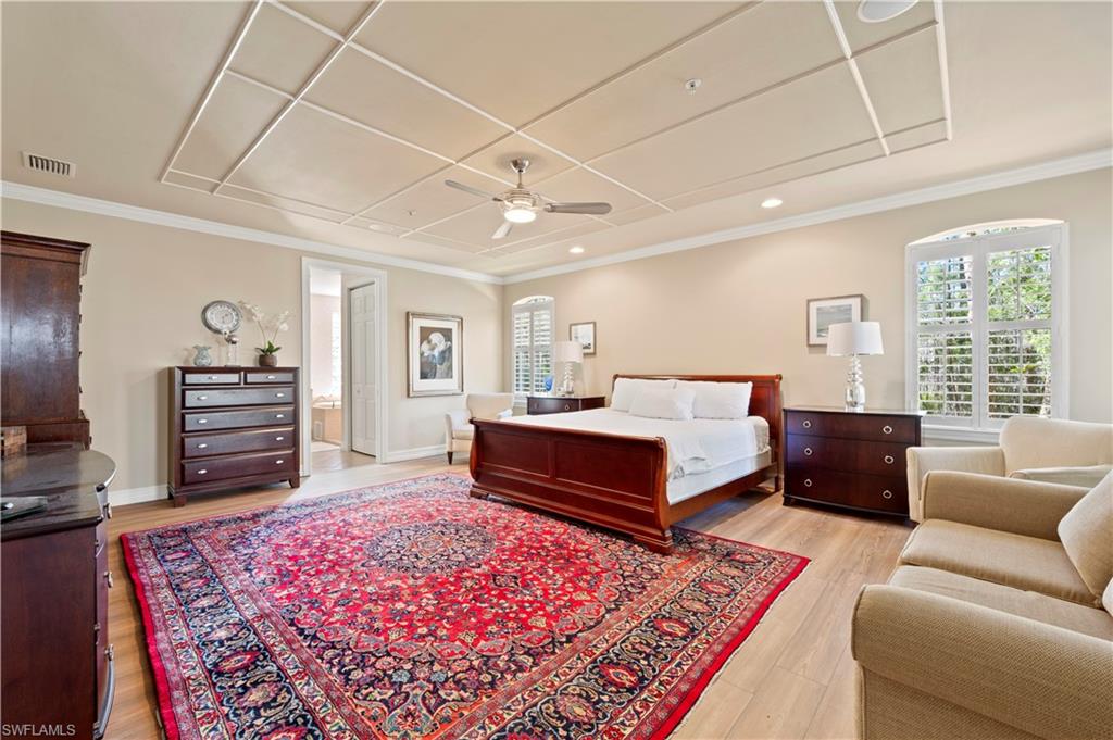 Bedroom featuring light wood-style flooring, a ceiling fan, and crown molding