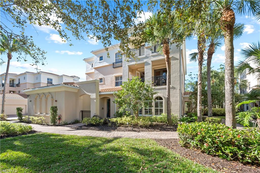 Mediterranean / spanish house with a balcony, stucco siding, a front lawn, and a tiled roof