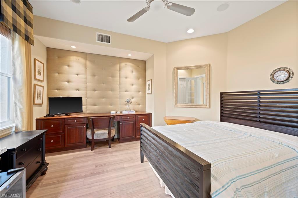Bedroom with light wood-style flooring, a ceiling fan, a desk, and recessed lighting