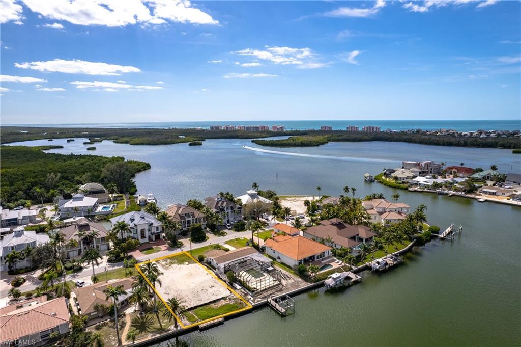 Aerial view of residential area featuring a nearby body of water