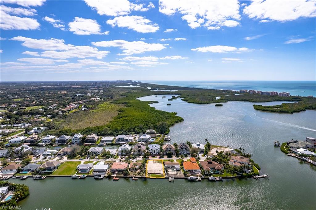 Aerial view of residential area featuring a large body of water