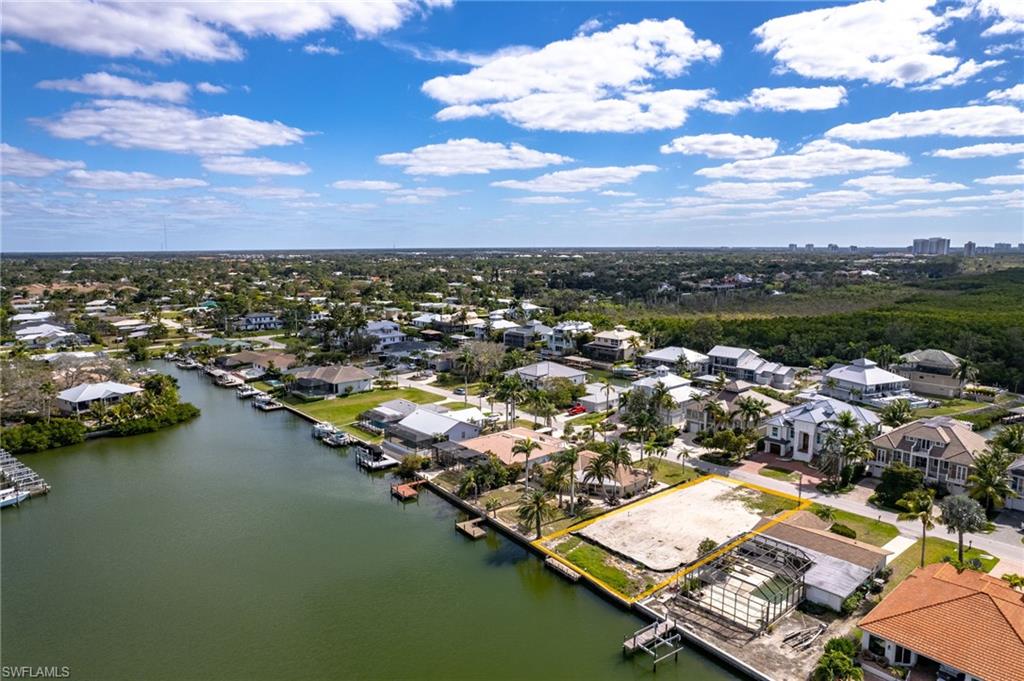 Aerial view of residential area featuring a nearby body of water