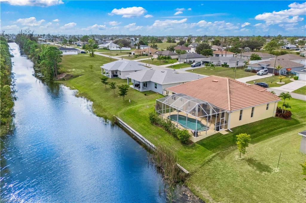 Aerial view of residential area featuring a large body of water