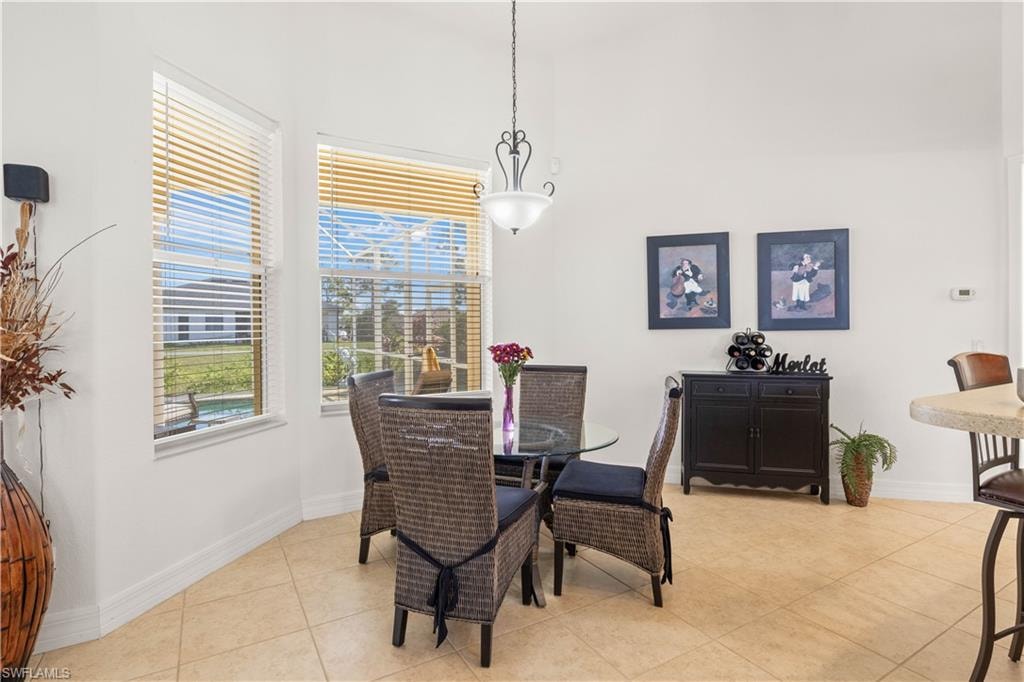 Dining space featuring baseboards and light tile patterned floors
