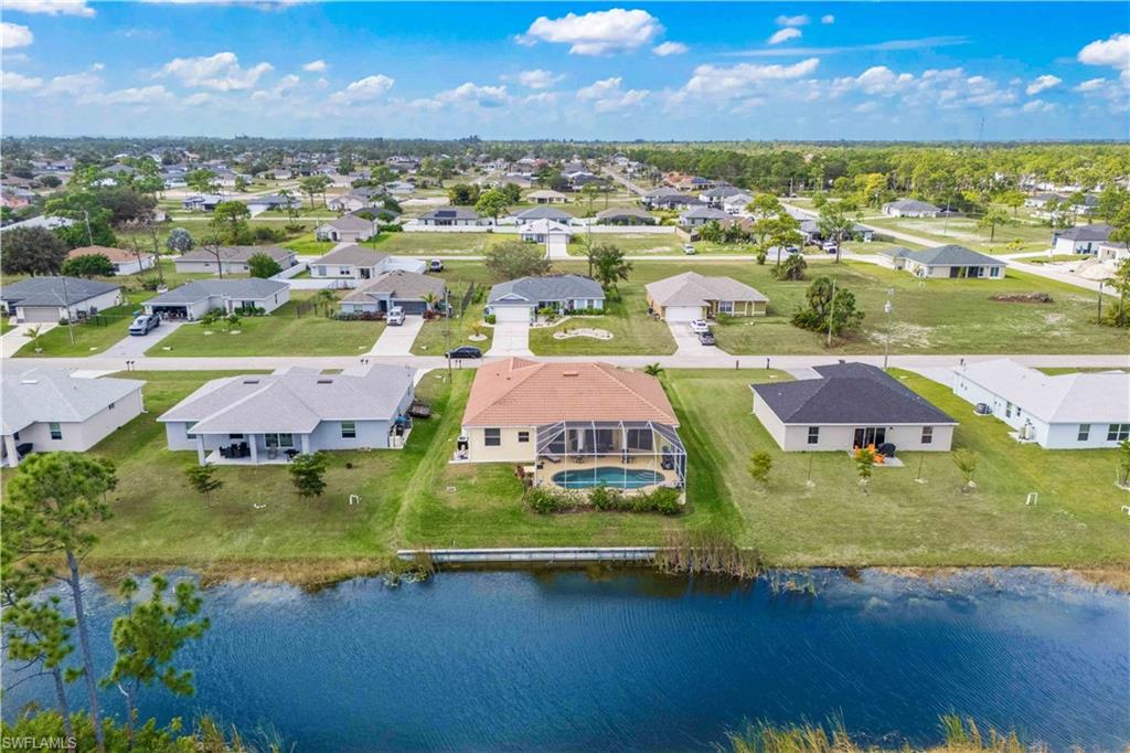 Aerial view of residential area featuring a nearby body of water