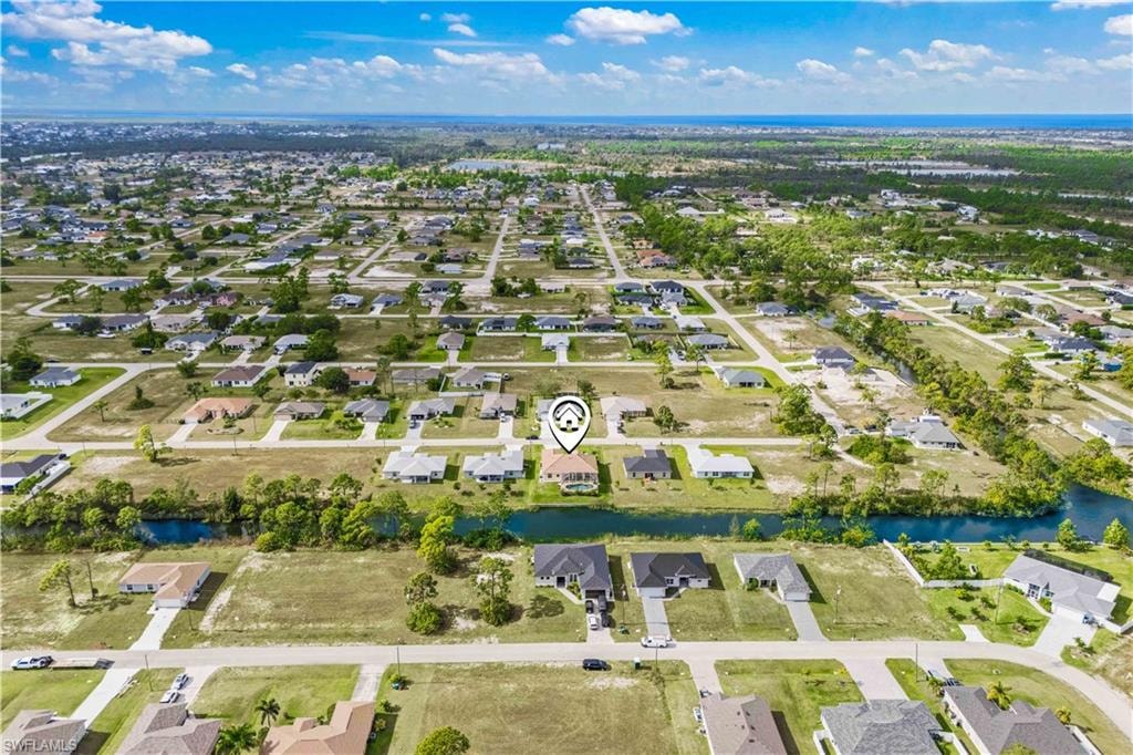 Aerial overview of property's location featuring nearby suburban area and a large body of water