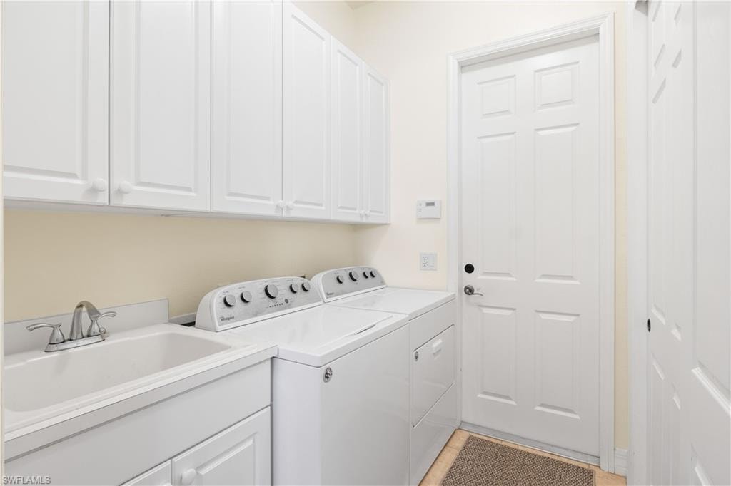 Laundry area featuring washer and dryer and cabinet space