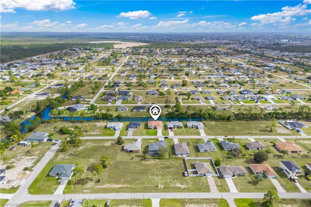 Aerial overview of property's location featuring nearby suburban area