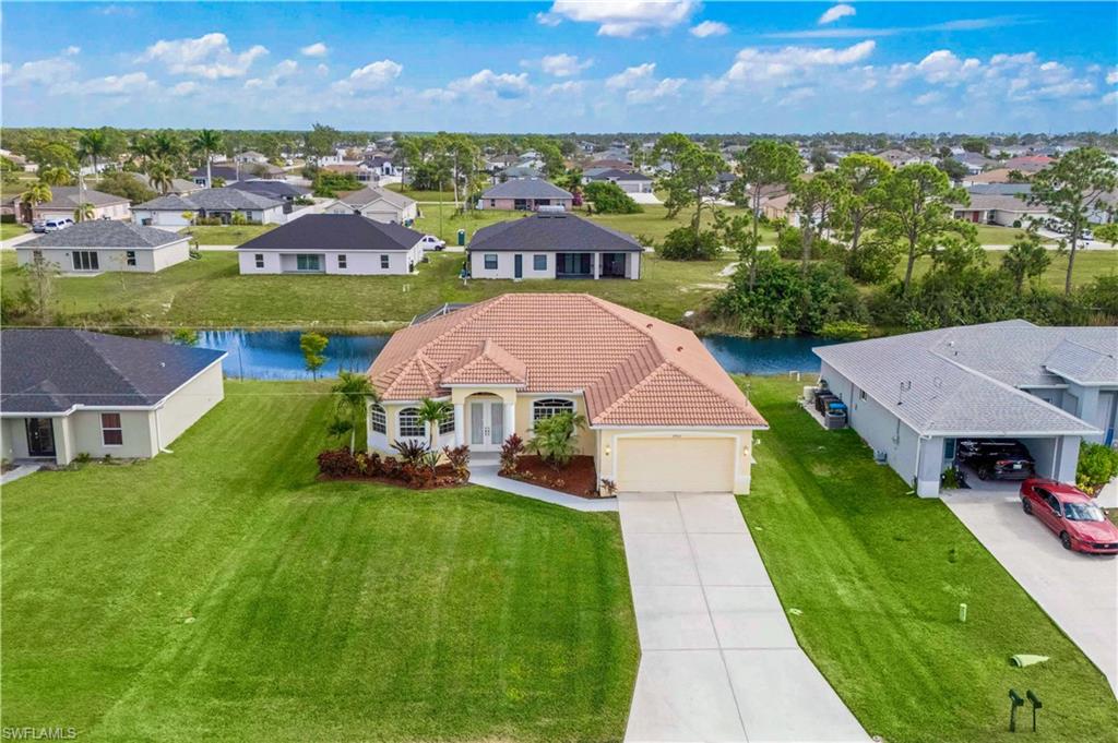 Aerial perspective of suburban area with a nearby body of water