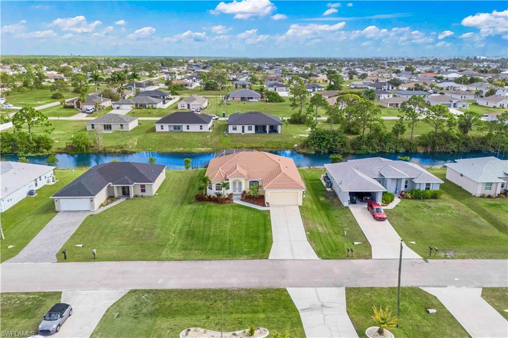 Aerial view of residential area featuring a large body of water