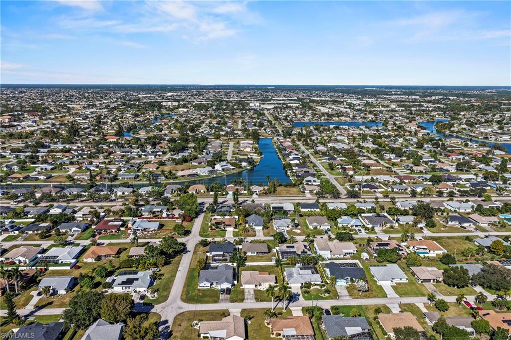Aerial overview of property's location featuring nearby suburban area and a large body of water
