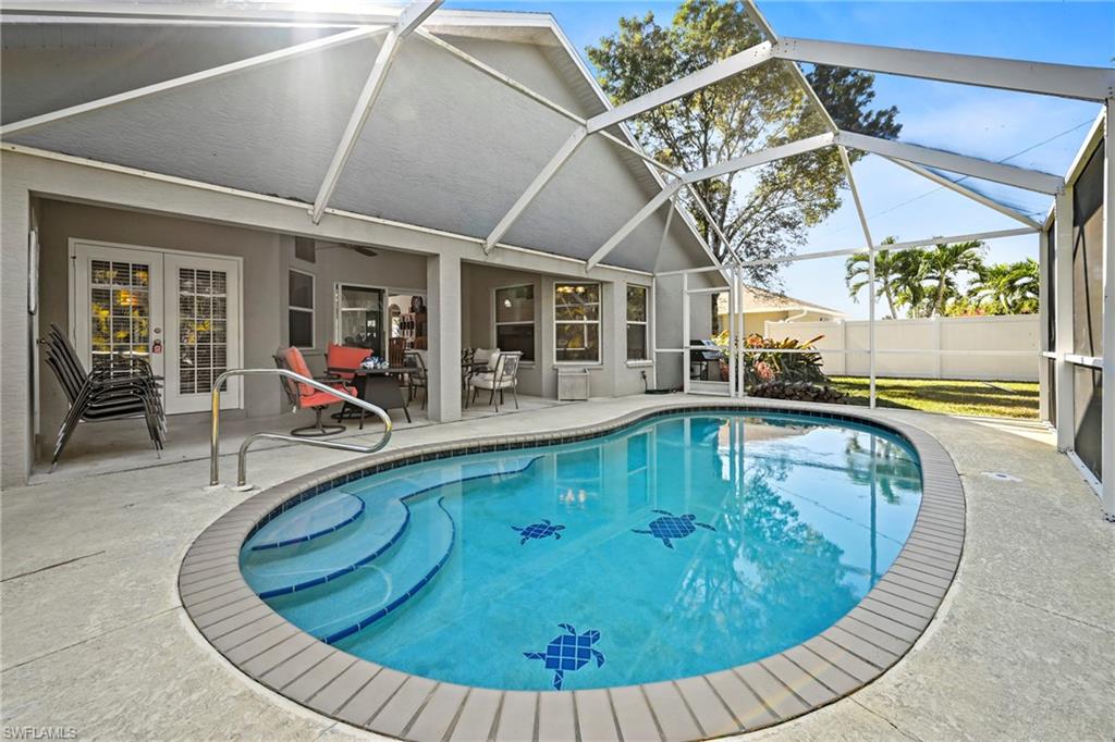 View of swimming pool with a patio, a sunroom, glass enclosure, and french doors
